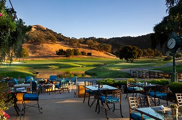 A patio featuring several tables and chairs arranged for outdoor dining and relaxation.