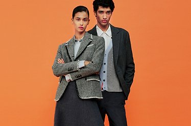 Male and female models posing sitting for the photo in YOOX fashion clothes