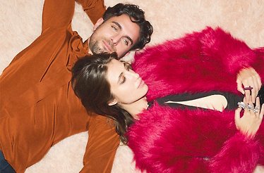 YOOX fashion, red fur coat on a woman and brown shirt on a man.