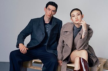 Male and female models posing sitting for the photo in YOOX fashion clothes