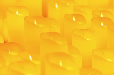Close up of burning yellow candles.