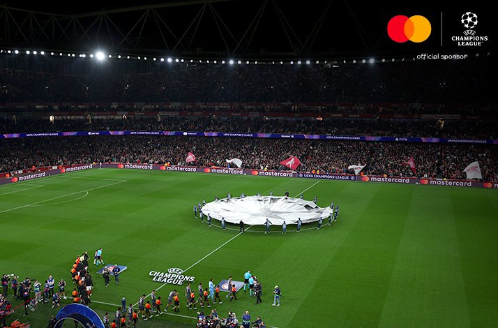 Large ball shaped flag on the middle of the football field before the UEFA match.
