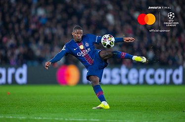A football player is hitting the ball during Paris Saint-Germain versus AS Monaco during UEFA Champions league knockout play-off second leg.