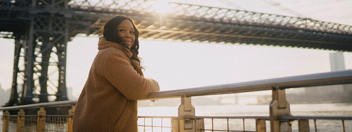 Roniesia Godfrey is standing beside bridge in New York.