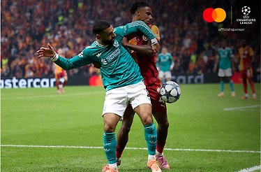 Liverpool and Galatasaray players battle for the ball during a UEFA Champions League match.