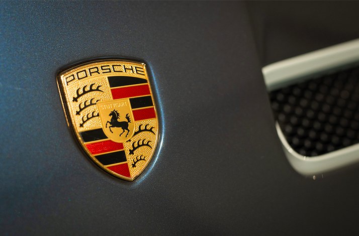 Close up of the Porsche logo badge.