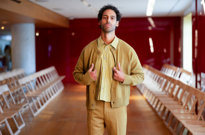 A male model wearing a tan casual outfit from a fashion collection at Galeries Lafayette Paris Haussmann.