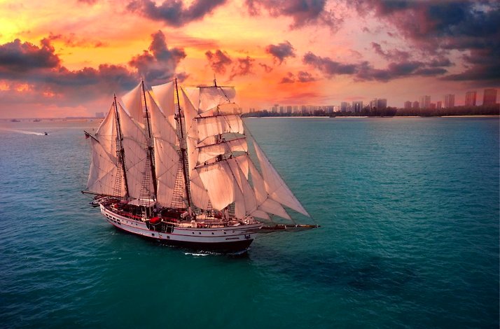 Aerial view of the Royal Albatross sailing at sunset.