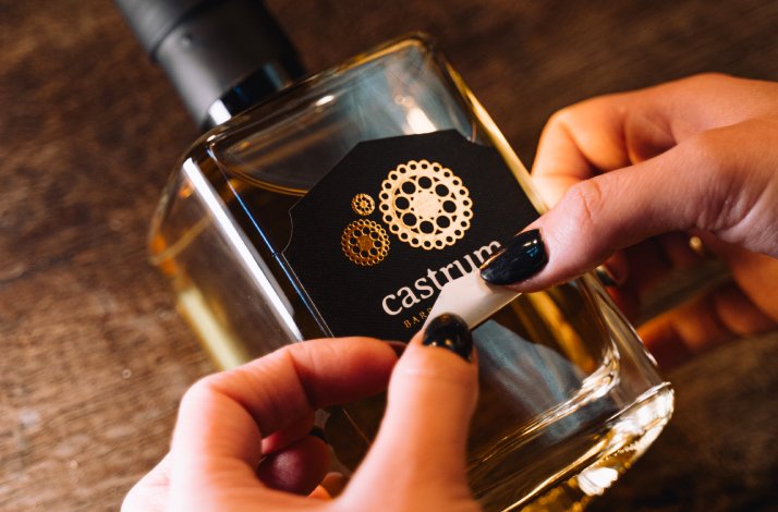 A bottle of Castrum gin in a woman’s hands.