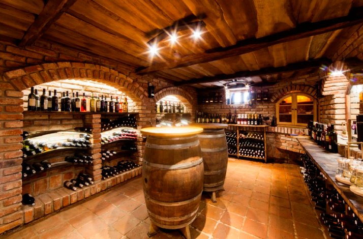 Castrum gin distillery premises with barrels and multiple bottles of award-winning Slavonian spirits.