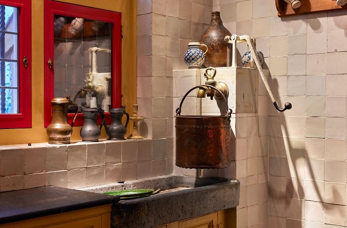 Dine under glowy candlelight in Rembrandt's seventeenth-century kitchen: In Amsterdam, Netherlands A kitchen scene displaying a sink alongside the old bucket at Rembrandt's former house.