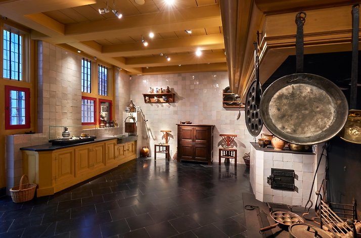 Dine under glowy candlelight in Rembrandt's seventeenth-century kitchen: In Amsterdam, Netherlands The wooden vintage kitchen featuring essential appliances at Rembrandt's former house.