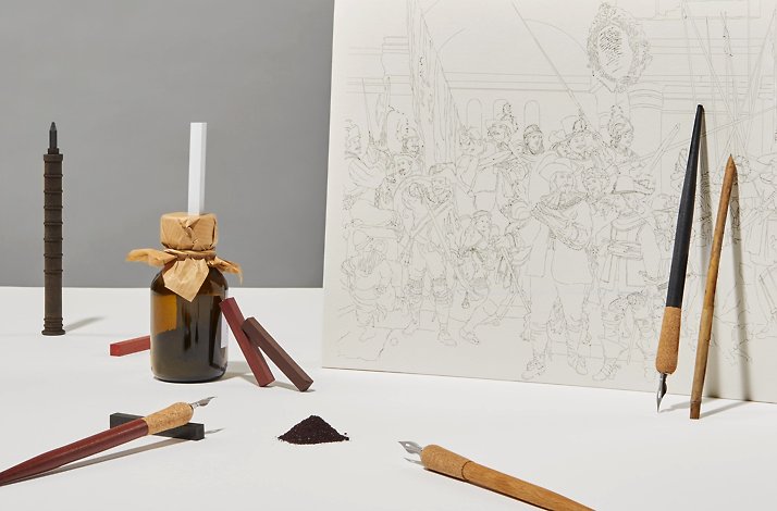 The reproduction of the painting by Dutch painter Rembrandt alongside with unique drawing tools at the table.
