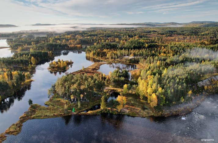 Escape to northern Sweden's Lapland for a summer or fall adventure: In Överstbyn, Sweden Cabins in a large forest landscape surrounded by a river