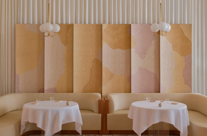 Minimal interior design of Singapore's Odette, showcasing light color tone wall and seatings.