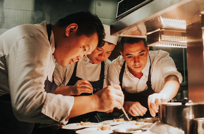 Chef Julien Royer crafting the dishes with his chefs, before serving.