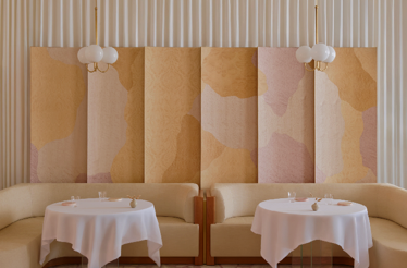 Minimal interior design of Singapore's Odette, showcasing light color tone wall and seatings.