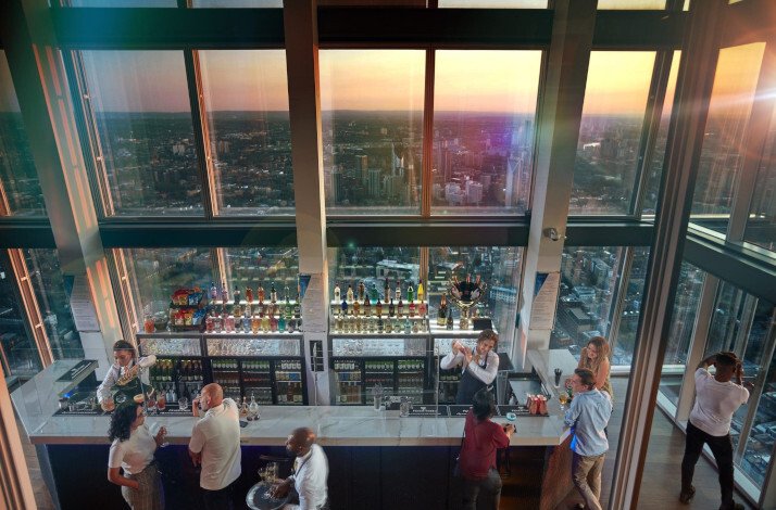 Participants on the 69th floor of London's tallest skyscraper, The Shard, enjoying drinks from the bar and viewing the city from above.