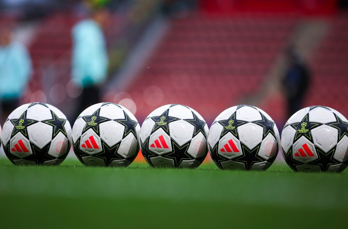 Footballs arranged in a line on the field.