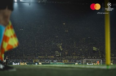 Football fans photographed at stadium stands during an UEFA Champions League match
