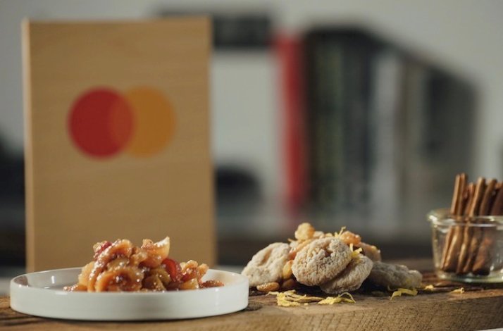 Dessert leftovers and pantry supplies are turned into two delicious desserts displayed on the table. Mastercard logo at the backend.