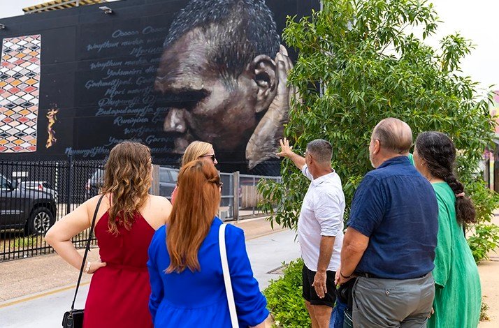 Participants looking at Darwin Street Art - Gurrumul Mural.