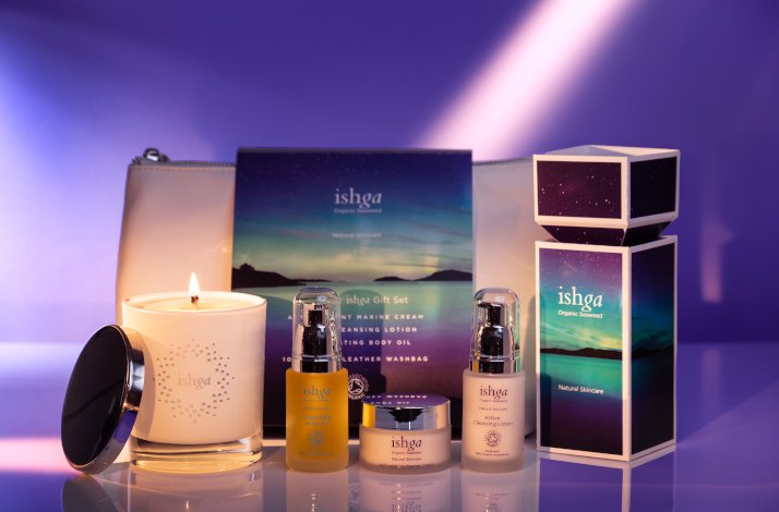 ishga Skin Care products line with a lit candle