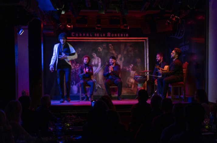 A flamenco performance on a dimly lit stage at Corral de la Morería.