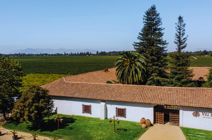 Aerial view of the beatiful green landscape and building at Viu Manent Winery