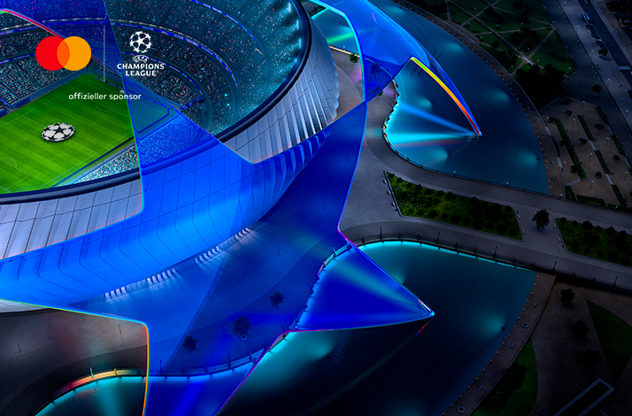 Aerial view of illuminated UEFA Champions League star sculpture in blue, with Mastercard logo and text 'offizieller sponsor' upper-left.
