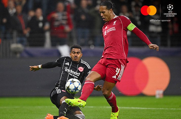 Liverpool's Virgil van Dijk, wearing the captain's armband, holding off a Frankfurt tackle; Logos of Mastercard and UEFA Champions League in the upper-right corner.