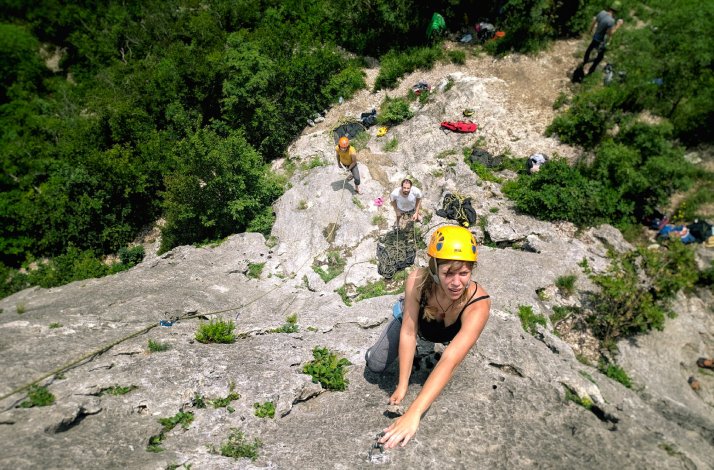 Group of people climbing a mountain with special equipment and insurance on the second day of their stay at Buzet's Vela Vrata hotel