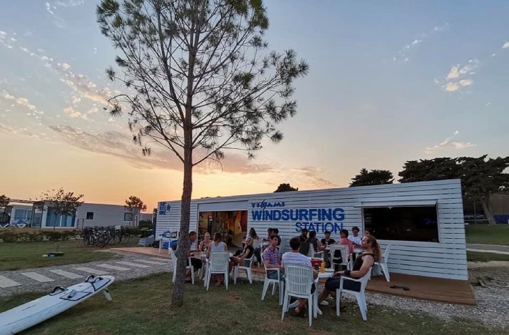 A group of people enjoying barbecue and cocktails next to Tsunami Windsurfing station
