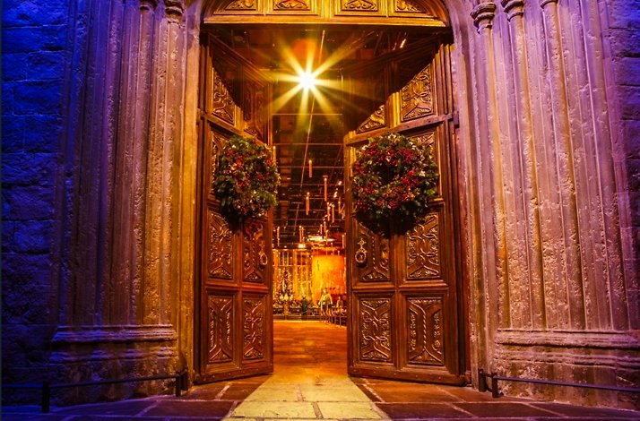 High doors solemnly opening with Christmas wreaths.