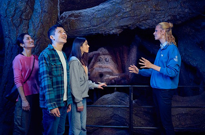 Three people are listening to the tour guide at Warner Bros Studio Tour Lodon.