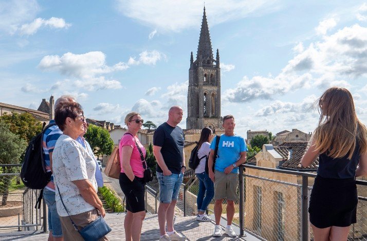 A group of tourists visiting one of the landmarks during tour around Bordeaux vineyards.