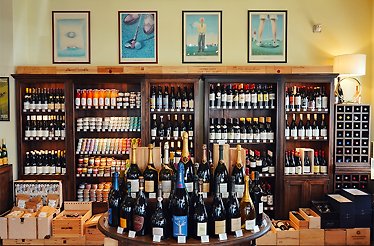 A showcase filled with a variety of bottles of drinks at Le Manoir.