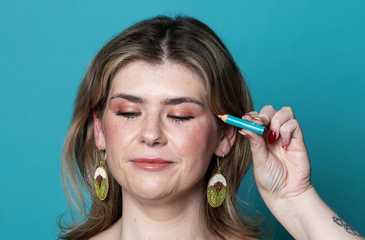 A model holding Rose Quartz eyeshadow up to her face.