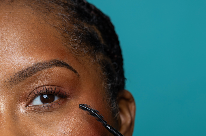 Close-up of a model applying Uprise mascara by Cheekbone Beauty.