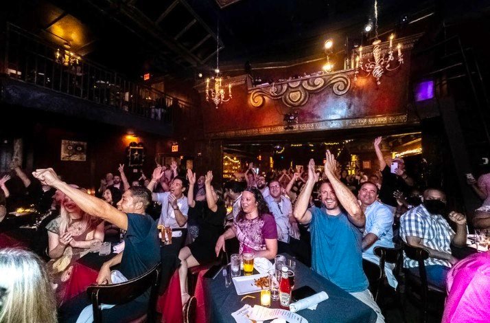 People having fun at Shake, Rattle & Roll Dueling Pianos evening event.