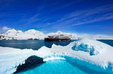 A MS Roald Amundsen sailing between blocks of ice