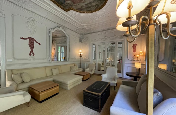 Club Matador lounge featuring ornate white decor, elegant seating, and framed artwork.