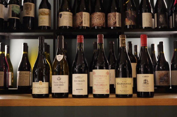 Shelves lined with assorted wine bottles, showcasing a curated selection from the cellar at Club Matador.