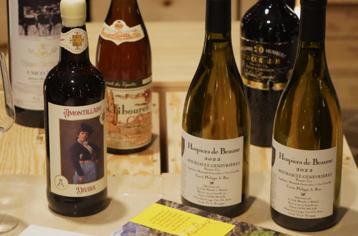 Close-up of several wine bottles on a table at Club Matador, highlighting labels and vintages prepared for tasting.