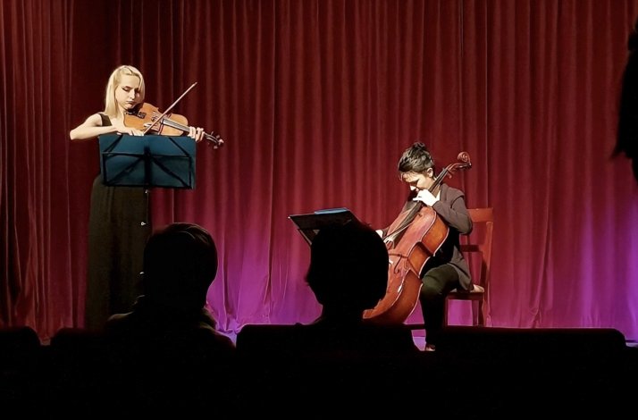 Violinist and cellist performing Vivaldi's The Four Seasons at Club Matador, a members-only cultural venue in Madrid.