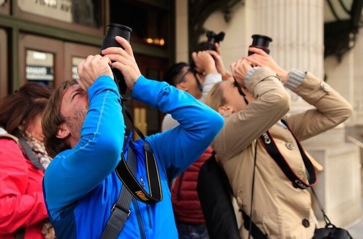 Participants taking photos of New York iconic landmarks under instructions of professional photographer.