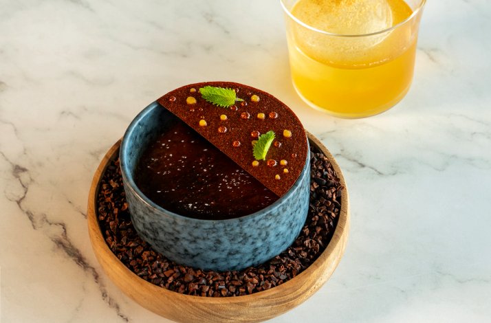 A chocolate dessert and a refreshing drink on the table