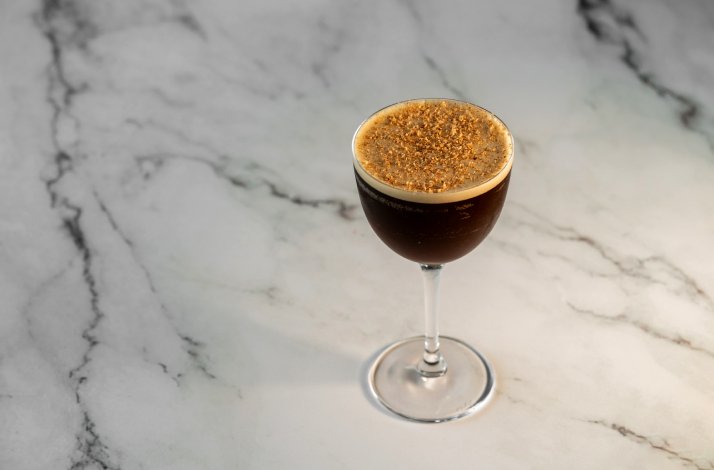 A glass with a cocktail on the table