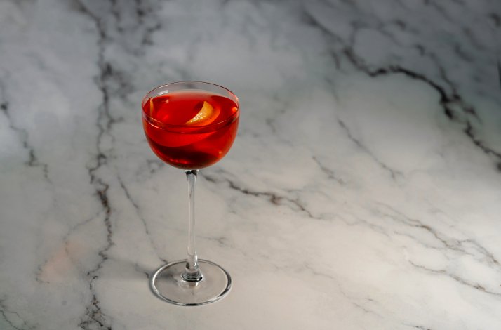 A glass with a cocktail on the table
