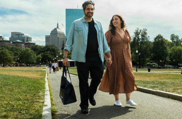 A couple walking in the park smiling